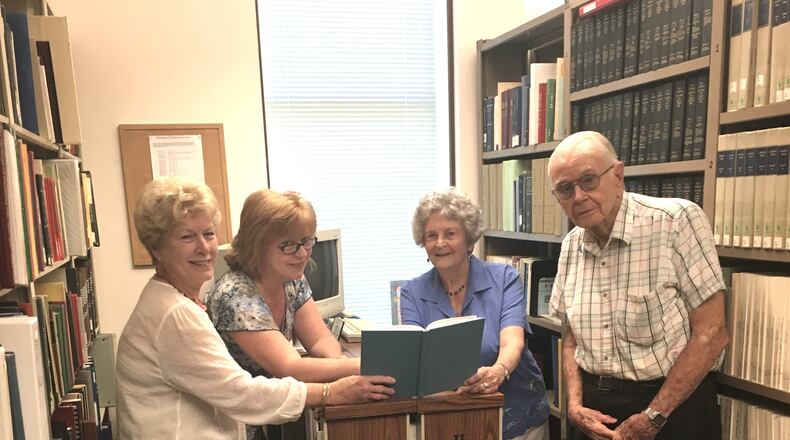l-r: Gwinnett Historical Society volunteer and co-president Betty Warbington, volunteer and research specialist Katie Dawson, Anne Kelley Huppertz and her brother Paul V. Kelley in the GHS library searching for Kelley/Loveless family history. Photo by Karen Huppertz for the AJC
