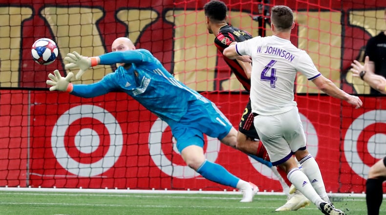 Atlanta United goalkeeper Brad Guzan blocks a shot by Orlando City defender Will Johnson during the first half of a MLS soccer match on Sunday, May 12, 2019, in Atlanta. Atlanta United won the game 1-0. Curtis Compton/ccompton@ajc.com