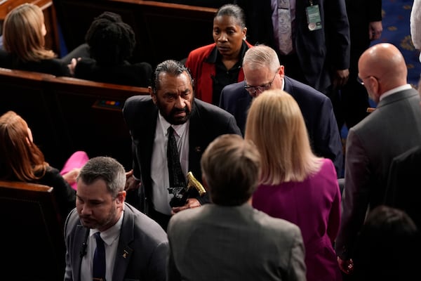 U.S. Rep. Al Green, a Democrat from Texas, is escorted from the House chamber as President Donald Trump addresses a joint session of Congress in Washington on Tuesday.