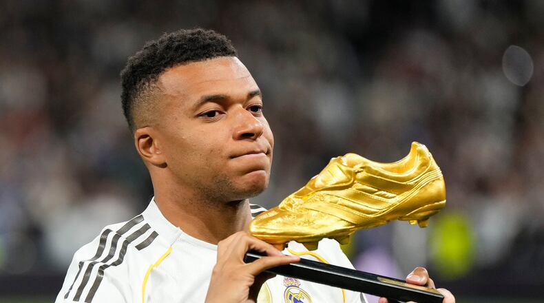 Real Madrid's Kylian Mbappe poses with the Golden Boot award before the Spanish La Liga soccer match between Real Madrid and Valencia in Madrid, Spain, Saturday, Nov. 1, 2025. (AP Photo/Manu Fernandez)