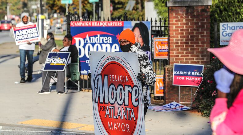 Brian Duncan (center) joined other campaigners in front of the C.T. Martin Natatorium and Recreation Center on Election Day last week. (John Spink / John.Spink@ajc.com)
