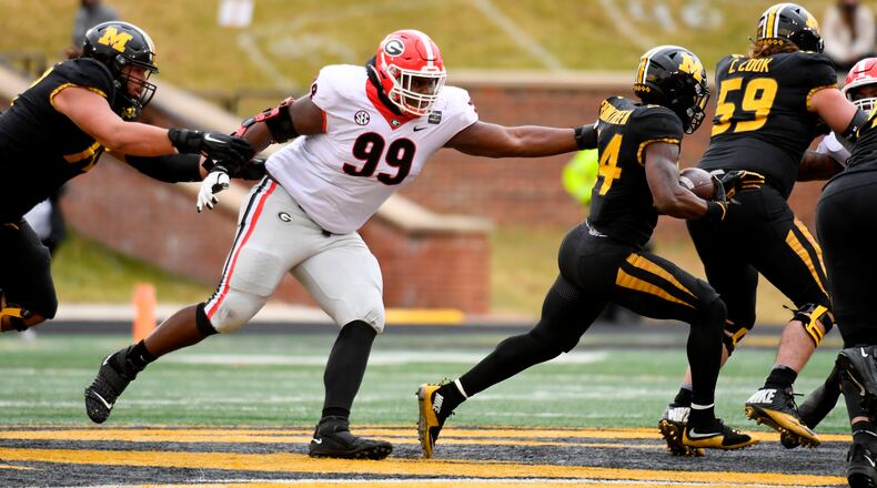 Georgia defensive lineman Jordan Davis (99) defends as Missouri running back Larry Rountree III (right) runs with the ball Saturday, Dec. 12, 2020, in Columbia, Mo. (L.G. Patterson/AP)