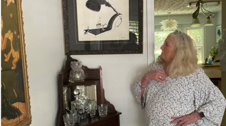 Valerie Jackson admires one of Dr. Seuss’ pieces of art entitled “Booby Trap.” (Photo Courtesy of Cathy Cobbs)