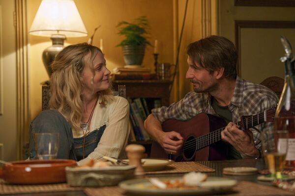 This image released by Focus Features shows Carey Mulligan, left, and Tom Basden in a scene from "The Ballad of Wallis Island." (Focus Features via AP)