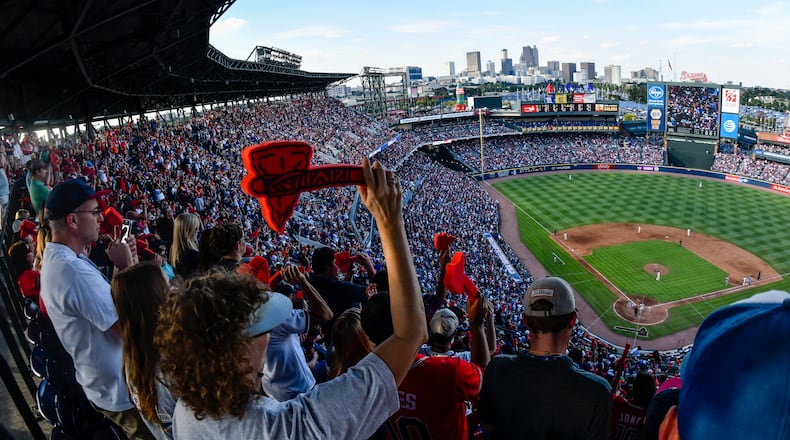 Atlanta Braves fans cheer with a tomahawk chop during the ninth inning of a baseball game against the Detroit Tigers, and the Braves' final game at Turner Field, Sunday, Oct. 2, 2016, in Atlanta. The franchise is planning on starting next season at SunTrust Park which is under construction in Cobb County. (AP Photo/John Amis)