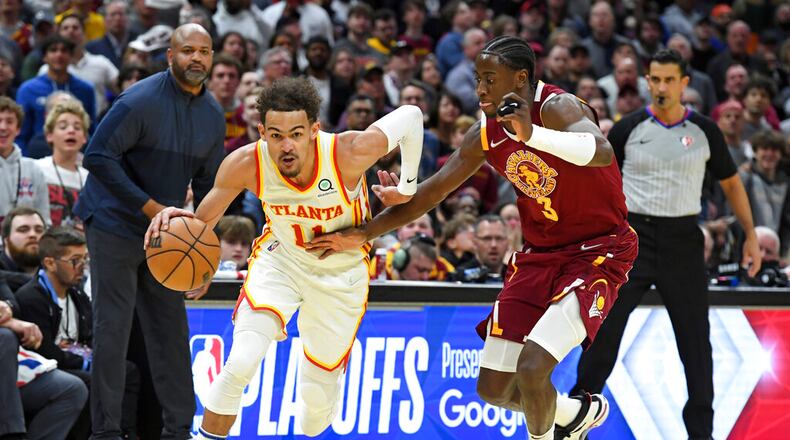 Atlanta Hawks' Trae Young (11) drives against Cleveland Cavaliers' Caris LeVert (3) in the second half of an NBA play-in basketball game Friday, April 15, 2022, in Cleveland. (AP Photo/Nick Cammett)