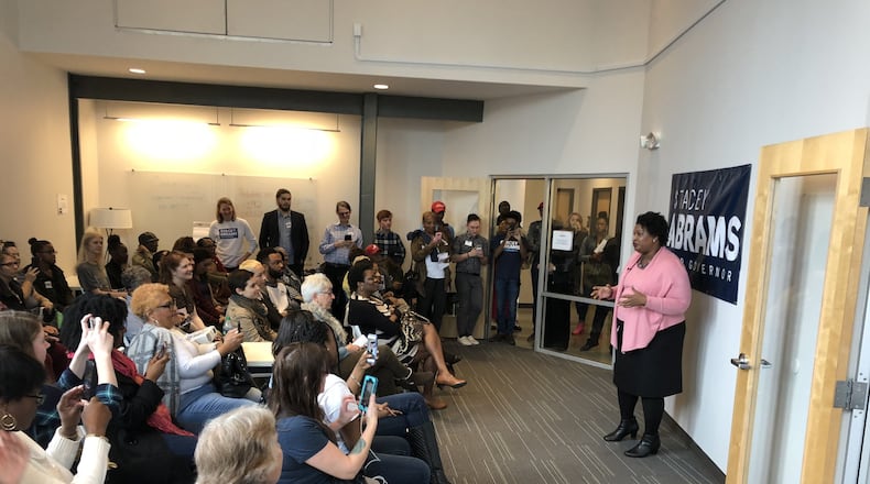 Democrat Stacey Abrams thanks dozens of volunteers working in her campaign for governor. Abrams has veered from a traditional strategy of hoarding cash until closer to the May 22 primary in order to build a get-out-the-vote effort now.