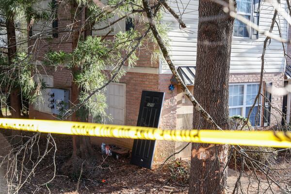 A luxury SUV carrying two Georgia football players and two recruiting staff members crashed into utility poles and trees before striking this Athens apartment building around 2:45 a.m. on Jan. 15. Police were at the scene for hours after the crash that killed football player Devin Willock and recruiting analyst Chandler LeCroy.  (Natrice Miller/natrice.miller@ajc.com) 