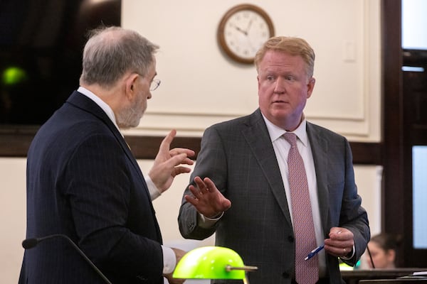 John Christy (left), an attorney for Morgan County property owners, speaks to Charlie Peeler, an attorney for the Georgia Department of Economic Development, at a court hearing Wednesday, Aug. 13, 2025, at the Morgan County Courthouse in Madison. (Arvin Temkar/AJC)