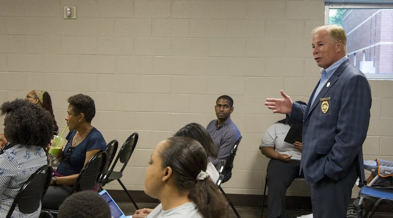 Cobb Police Chief Mike Register speaks with renters in South Cobb at the South Cobb Recreation Center in Austell on May 9. Register has been in his position for almost a year and has made it to a priority to address community-police relations. (REANN HUBER/REANN.HUBER@AJC.COM)