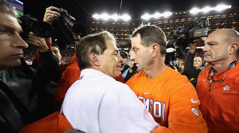 Alabama head coach Nick Saban (left) might have embraced Clemson head coach Dabo Swinney after the 2019 championship, but Saban now offers advice for the struggling Swinney. (Ezra Shaw/Getty Images/TNS)