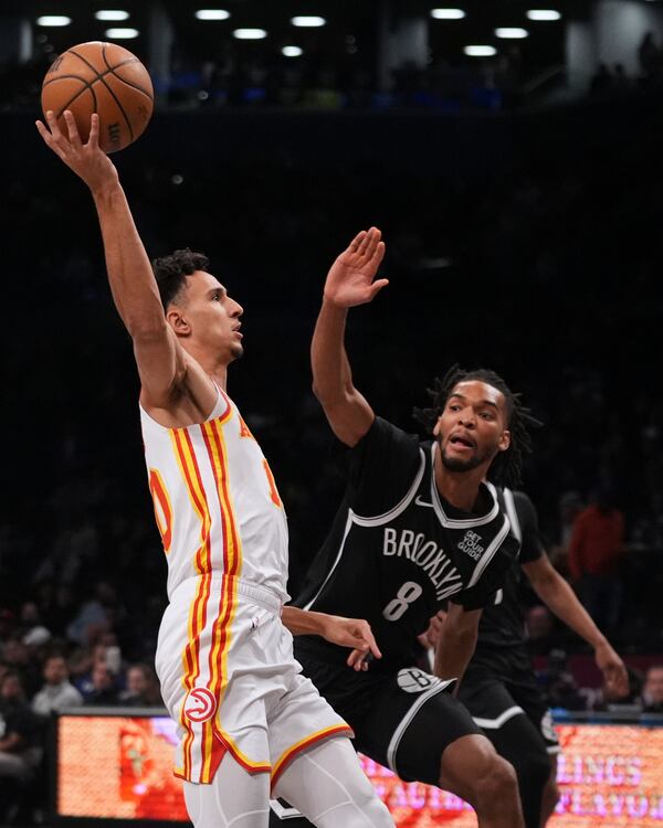 Atlanta Hawks' Zaccharie Risacher (10) drives past Brooklyn Nets' Ziaire Williams (8) during the first half of an NBA basketball game Thursday, April 10, 2025, in New York. (AP Photo/Frank Franklin II)