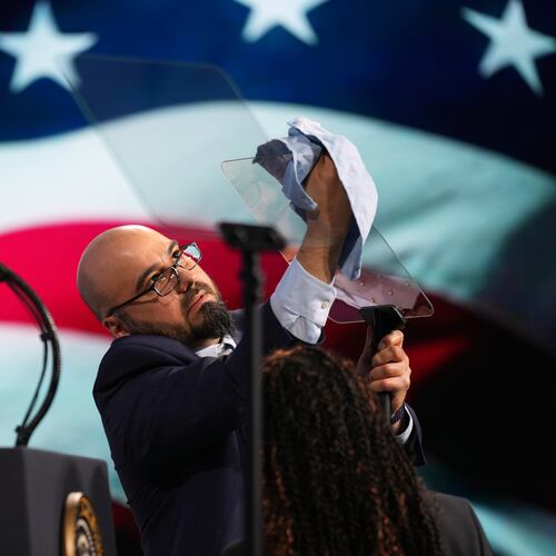 FILE - Gabriel Perez cleans the teleprompter before President Donald Trump speaks at the Future Investment Initiative Institute's summit, March 27, 2026, in Miami Beach, Fla. (AP Photo/Mark Schiefelbein, File)