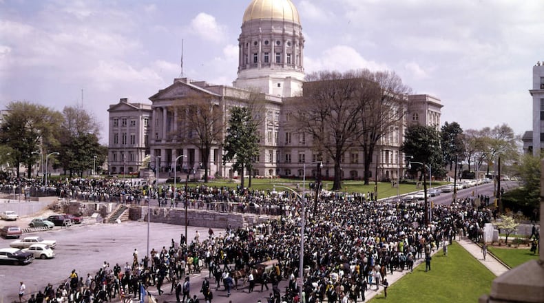 The funeral procession for the Rev. Martin Luther King Jr. approaches the Georgia Capitol building on Tuesday, April 9, 1968, in Atlanta. Many Americans publicly mourned and protested the civil rights leader’s murder. Others branded him a troublemaker who got what he deserved, writes guest columnist Stan Deaton. (J.C. Lee/AJC Collection at GSU Library)