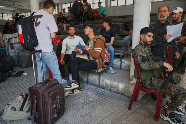 Druze students who fled their dorms at Damascus University arrive to take shelter in Jaramana suburb, a day after clashes between members of the minority Druze sect and pro-government fighters left at least four people dead in the southern suburb of Jaramana, Damascus, Syria, Tuesday, April 29, 2025. (AP Photo/Omar Sanadiki)