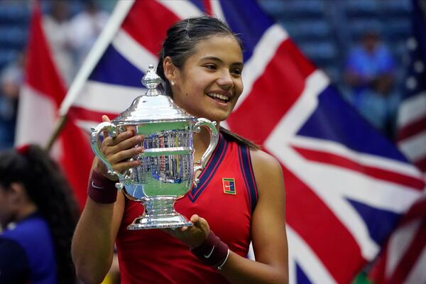 FILE - Emma Raducanu, of Britain, holds up the U.S. Open championship trophy after defeating Leylah Fernandez, of Canada, during the women's singles final of the U.S. Open tennis championships on Sept. 11, 2021, in New York. (AP Photo/Elise Amendola, File)