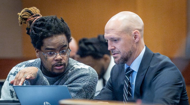 YSL defendant Shannon Stillwell (left) speaks with defense attorney Max Schardt at the Fulton County Courthouse Tuesday, September 12, 2023. (Steve Schaefer/steve.schaefer@ajc.com)