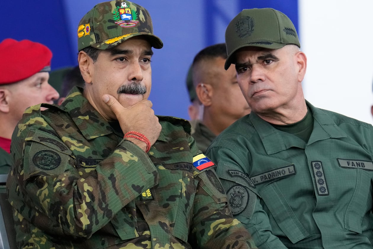 Venezuelan President Nicolás Maduro, left, listens to Defense Minister Vladimir Padrino López during a government-organized civic-military march in Caracas, Venezuela, Tuesday, Nov. 25, 2025. Padrino López studied psychological operations at a special school for Latin American troops at Fort Benning. (Ariana Cubillos/AP)