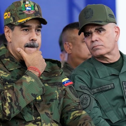 Venezuelan President Nicolás Maduro, left, listens to Defense Minister Vladimir Padrino López during a government-organized civic-military march in Caracas, Venezuela, Tuesday, Nov. 25, 2025. Padrino López studied psychological operations at a special school for Latin American troops at Fort Benning. (Ariana Cubillos/AP)