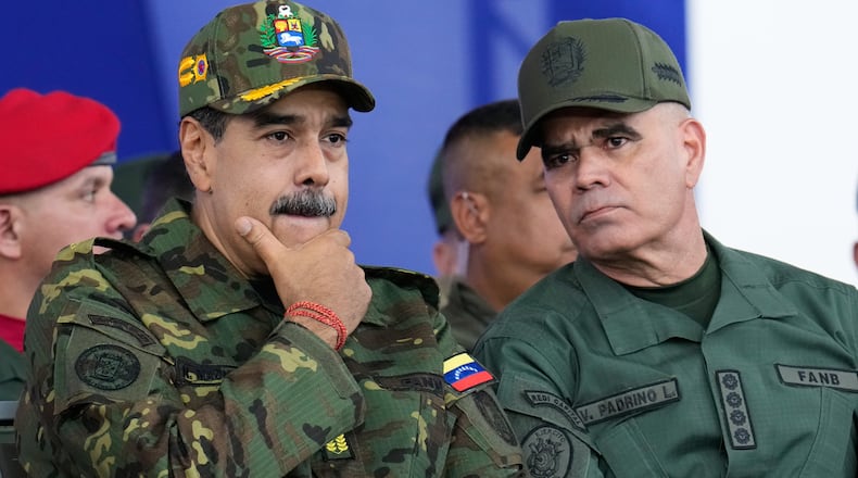 Venezuelan President Nicolás Maduro, left, listens to Defense Minister Vladimir Padrino López during a government-organized civic-military march in Caracas, Venezuela, Tuesday, Nov. 25, 2025. Padrino López studied psychological operations at a special school for Latin American troops at Fort Benning. (Ariana Cubillos/AP)
