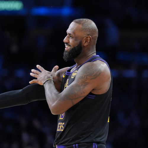 Los Angeles Lakers forward LeBron James (23) reacts to a three-point basket by guard Gabe Vincent during the second half of an NBA basketball game against the Utah Jazz Tuesday, Nov. 18, 2025, in Los Angeles. (AP Photo/Jae C. Hong)