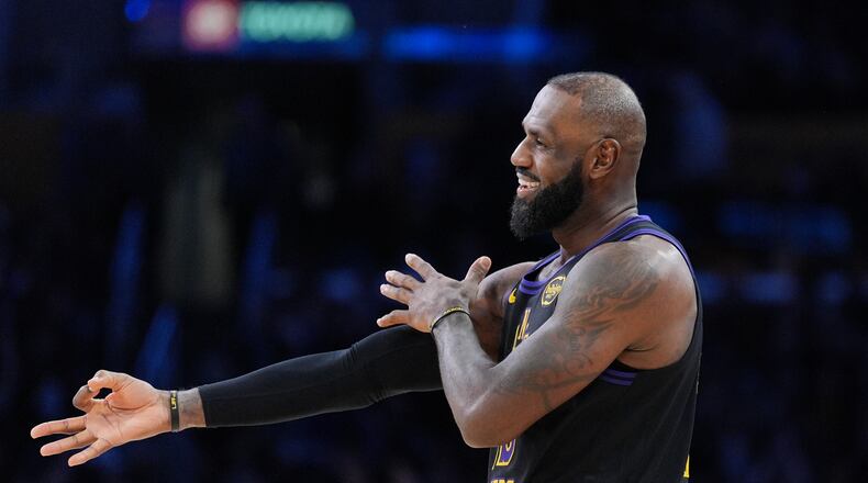 Los Angeles Lakers forward LeBron James (23) reacts to a three-point basket by guard Gabe Vincent during the second half of an NBA basketball game against the Utah Jazz Tuesday, Nov. 18, 2025, in Los Angeles. (AP Photo/Jae C. Hong)