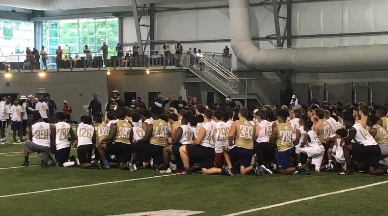 Participants at Georgia Tech coach Geoff Collins' showcase camp listen to Yellow Jackets defensive line coach Larry Knight (in bucket hat) at the Brock indoor practice facility on Monday January 3, 2019.