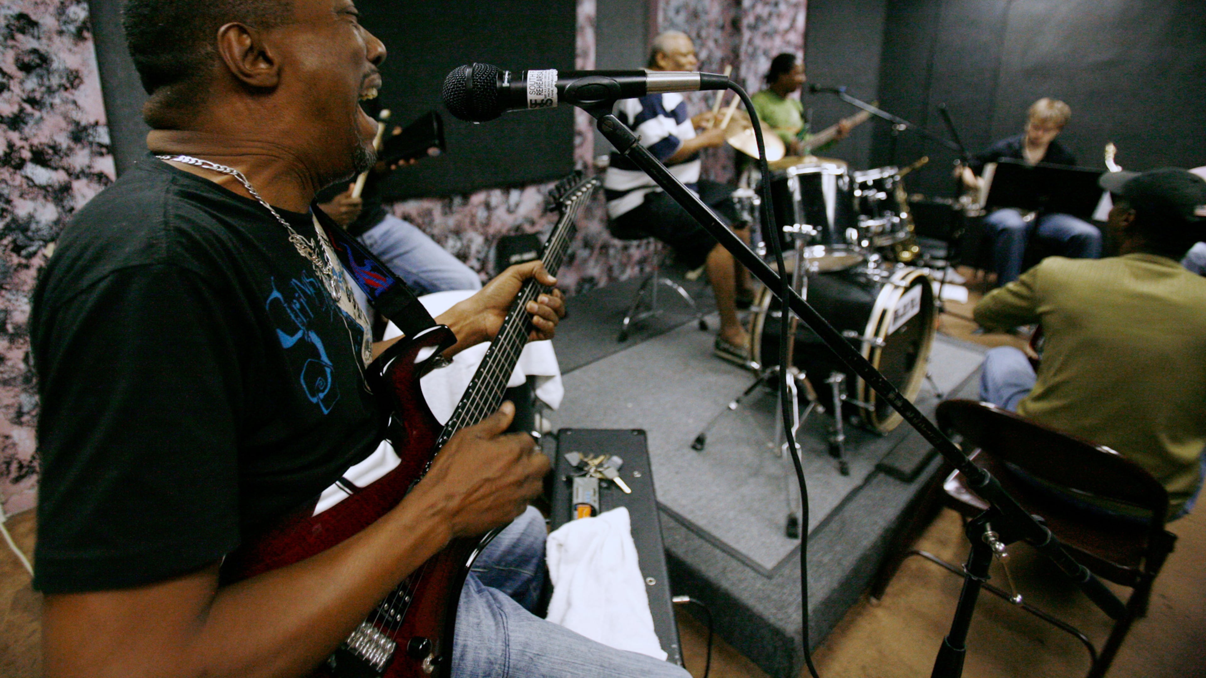 FILE - Andre "Dadou" Pasquet, left, sings and plays guitar with the Magnum compas band during a practice session in North Miami, Fla. Thursday, May 8, 2008. (AP Photo/Lynne Sladky, File)