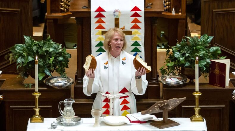 Bishop Sue Haupert-Johnson prays over a lof of bread before communion is served Sunday at the St. Mark United Methodist Church in Atlanta March 3, 2019.