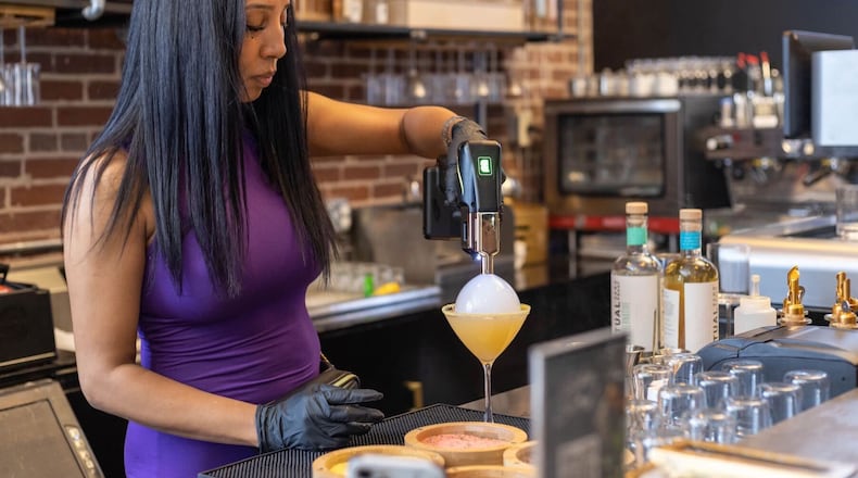 Aja Wolfe, the owner of Sober Social in Castleberry Hill, mixes a nonalcoholic drink behind the bar. / Courtesy of Aja Wolfe
