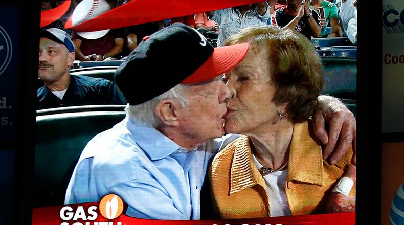 Former President Jimmy Carter kisses his wife, Rosalynn, on the "Kiss Cam" during a baseball game between the Braves and the Toronto Blue Jays on Thursday at Turner Field in Atlanta. Carter recently announced he has cancer. (AP Photo/John Bazemore)