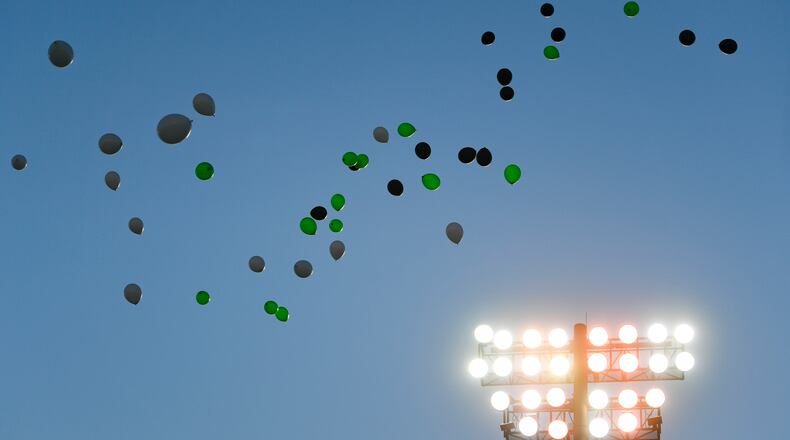Balloons are released before the start of a high school football game pitting Roswell against Milton, Friday, Sept. 20, 2019, in Roswell.