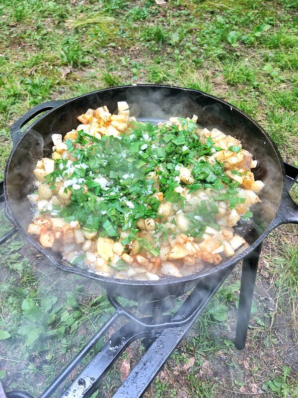 These russet potatoes have been crisped in an oversized cast-iron skillet with Benton’s signature smoky bacon and freshly harvested ramps. Chadwick Boyd for The Atlanta Journal-Constitution