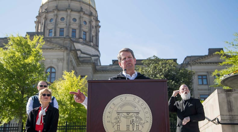 04/01/2020 - Atlanta, Georgia  - Gov. Brian Kemp (center) speaks during a press conference at Liberty Plaza, across the street from the Georgia State Capitol building, in downtown Atlanta, Wednesday, April 1, 2020. During the presser, Gov. Kemp ordered all Georgia K-12 schools to be closed until the end of the academic school year. He also said he will sign an order on Thursday forcing a "Stay-at-home" order for all Georgians until April 13.  (ALYSSA POINTER / ALYSSA.POINTER@AJC.COM)