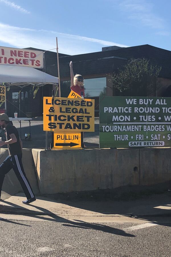 “Monique” helps flag down potential Masters ticket buyers for a scalper on Washington Road outside of Augusta National Golf Club Monday.