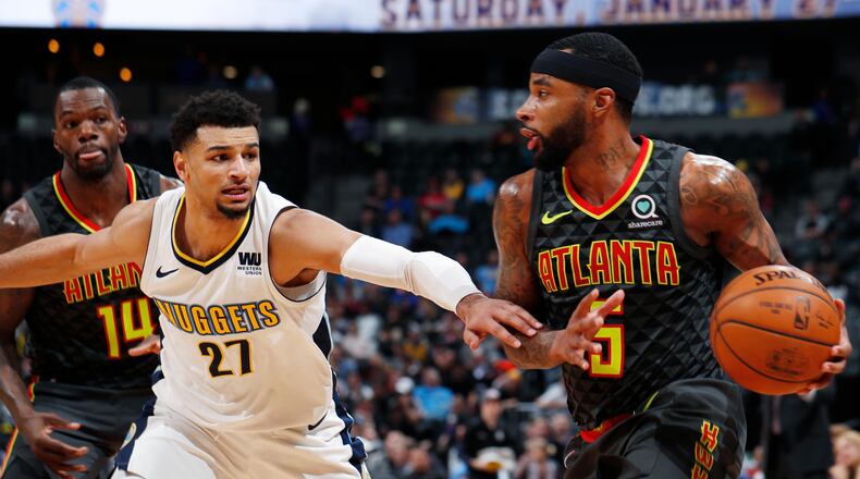 Denver Nuggets guard Jamal Murray, left, defends Atlanta Hawks guard Malcolm Delaney during the second half of an NBA basketball game Wednesday, Jan. 10, 2018. Atlanta won 110-97. (AP Photo/David Zalubowski)