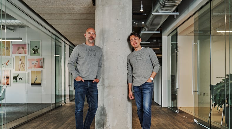 Mailchimp co-founders Dan Kurzius (left) and Ben Chestnut stand at their headquarters in Ponce City Market in 2021.