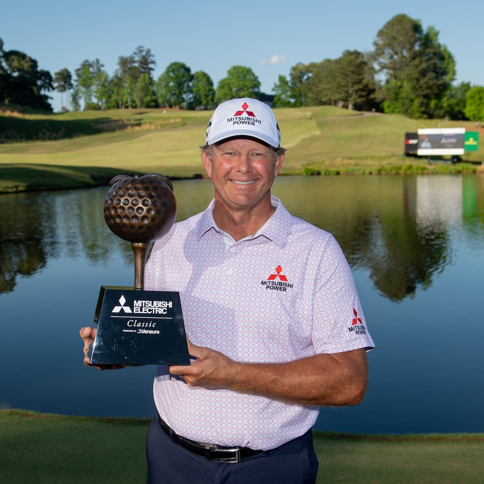 Retief Goosen holds the trophy for winning the Mitsubishi Electric Classic, April 26, 2026, at TPC Sugarloaf. Photo Kate Awtrey-King.