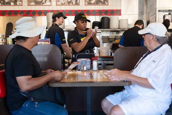 Tianna Dixon takes an order at the Waffle House on Peachtree Road in Brookhaven on Friday, Aug. 14, 2026. (Ben Gray for the AJC)