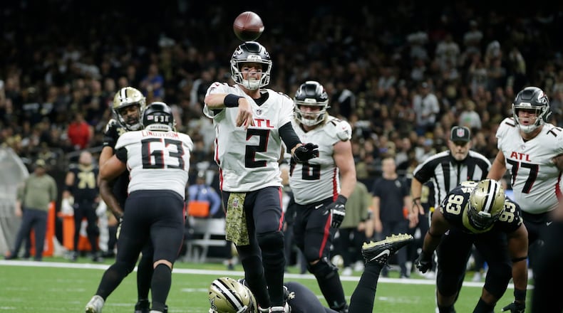 Falcons quarterback Matt Ryan steps out of a potential sack and delivers against the Saints Sunday. (AP Photo/Butch Dill)