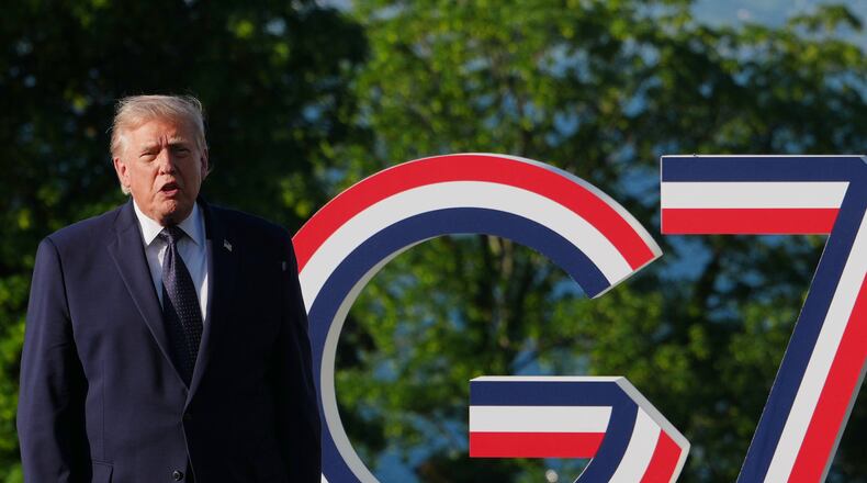 U.S. President Donald Trump talks as he greets France's President Emmanuel Macron and first lady Brigitte Macron at the G7 summit, Monday, June 15, 2026, in Evian-les-Bains, France. (AP Photo/Julia Demaree Nikhinson)