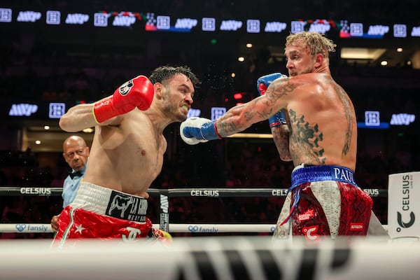 FILE - Julio Cesar Chavez Jr., left, throws a punch at Jake Paul during their cruiserweight boxing match, in Anaheim, Calif., June 28, 2025. (AP Photo/Etienne Laurent, File)