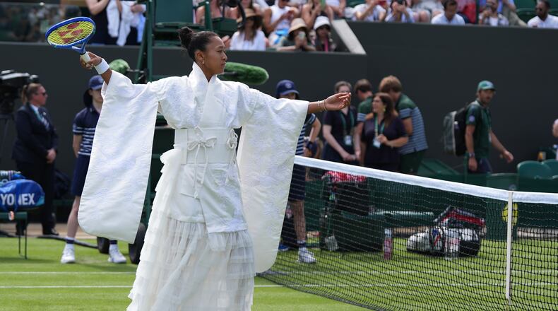 Naomi Osaka of Japan walks into the court to play against Elsa Jacquemot of France in their first round women's singles match at the Wimbledon Tennis Championships in London, Monday, June 29, 2026. (AP Photo/Maja Smiejkowska)