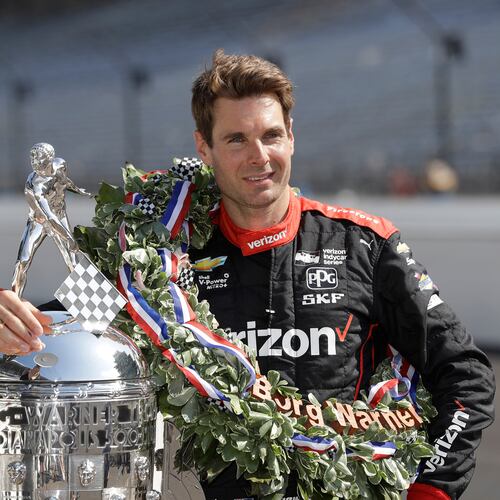 FILE Indianapolis 500 champion Will Power, of Australia, poses with the Borg-Warner Trophy during the traditional winners photo session on the start/finish line at the Indianapolis Motor Speedway, May 28, 2018, in Indianapolis. (AP Photo/Darron Cummings, File)