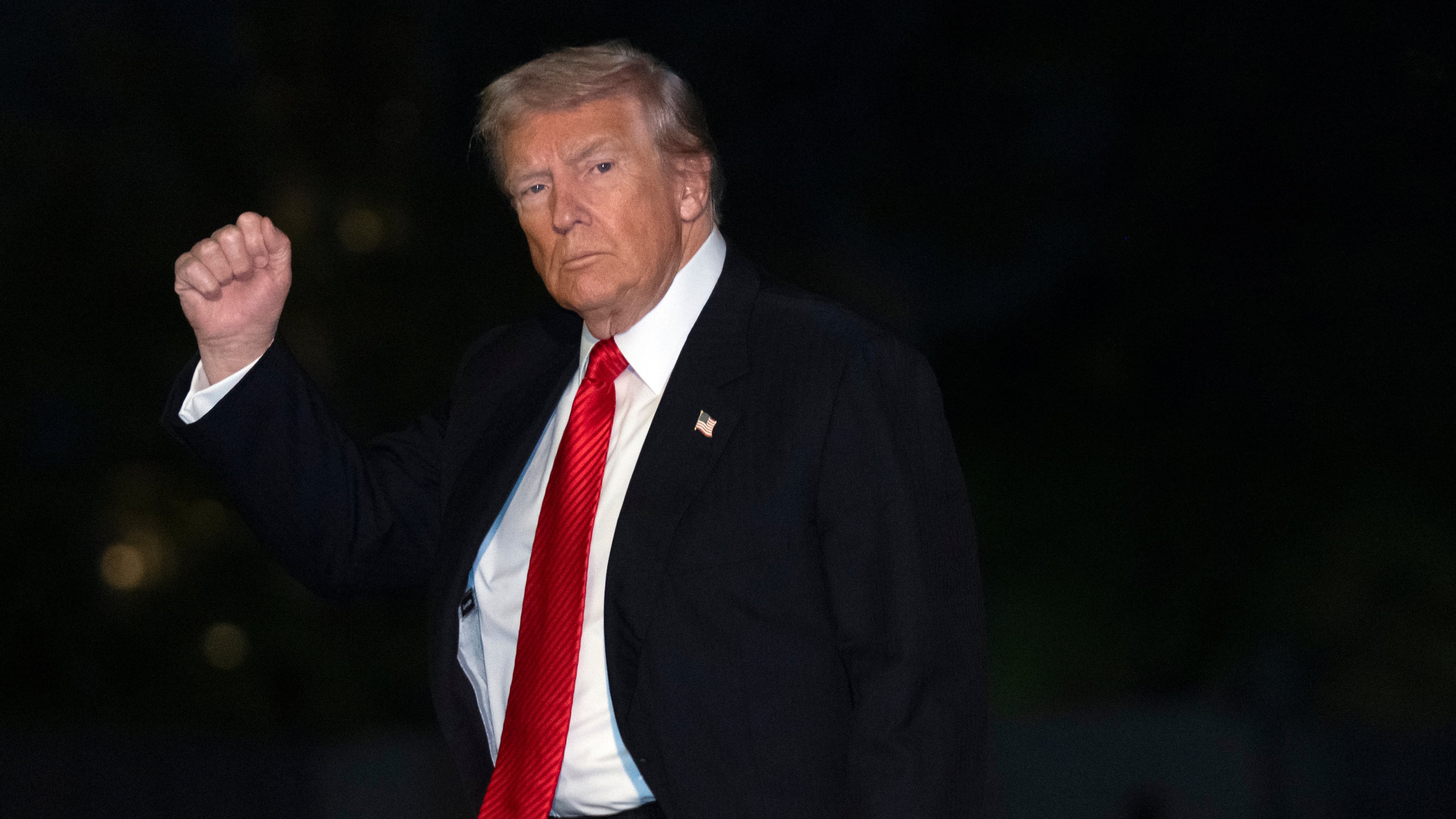 President Donald Trump gestures while walking across the South Lawn of the White House, Sunday, Nov. 2, 2025, in Washington, after returning from a trip to Florida. (AP Photo/Mark Schiefelbein)