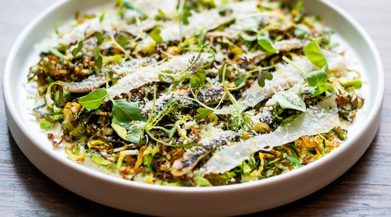 Watershed on Peachtree serves a take on a classic Caesar salad made with Brussels sprouts, guanciale, white anchovies and pistachios. CONTRIBUTED BY HENRI HOLLIS