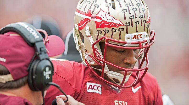 TALLAHASSEE, FL - NOVEMBER 23: Head coach Jimbo Fisher of the Florida State Seminoles talks to Jameis Winston #5 prior to the first play of the game against the Idaho Vandals at Doak Campbell Stadium on November 23, 2013 in Tallahassee, Florida. (Photo by Jeff Gammons/Getty Images) Head coach Jimbo Fisher of the Florida State Seminoles talks to quarterback Jameis Winston. (Jeff Gammons / Getty Images)