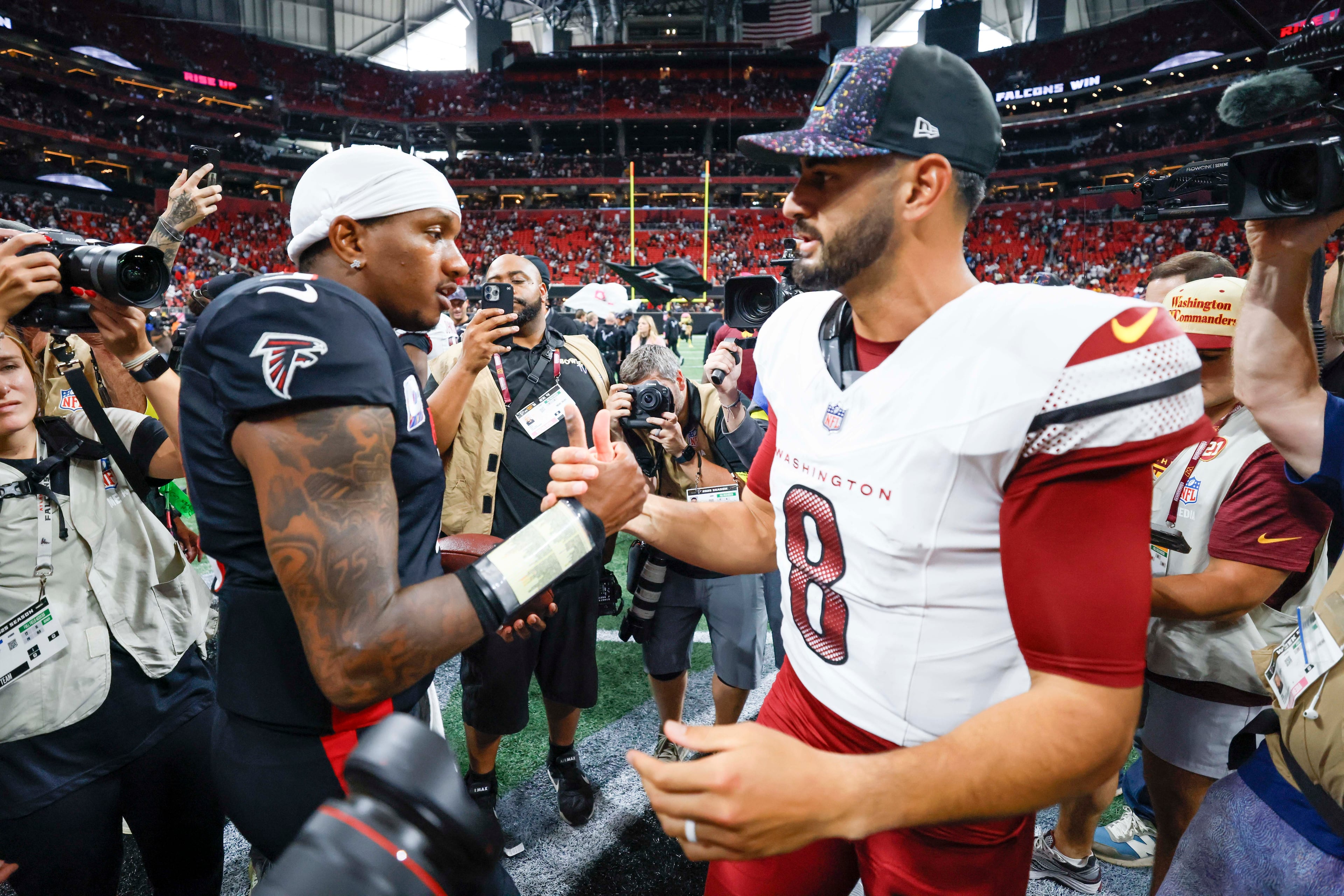 Atlanta Falcons quarterback Michael Penix Jr. shakes hands with Washington Commanders quarterback Marcus Mariota after the game at Mercedes-Benz Stadium in Atlanta on Sunday, September 28, 2025. The Atlanta Falcons defeated the Washington Commanders 34-27. (Miguel Martinez/AJC)