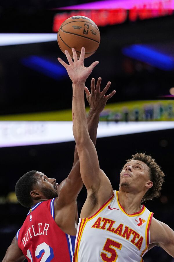 Philadelphia 76ers' Jared Butler (12) and Atlanta Hawks' Dyson Daniels go up for a jump ball during the second half of an NBA basketball game Friday, April 11, 2025, in Philadelphia. (AP Photo/Matt Rourke)