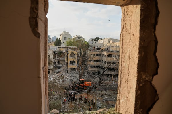 Rescue team work at the site where a missile launched from Iran struck Tel Aviv, Israel, Monday, June 16, 2025. (AP Photo/Baz Ratner)